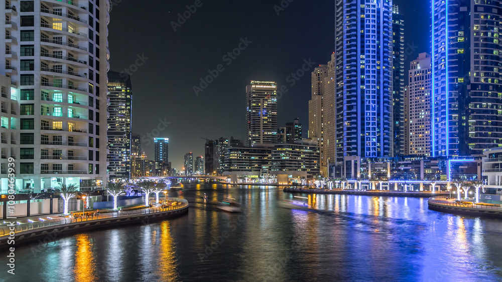 Naklejka premium Dubai Marina towers and canal in Dubai night timelapse hyperlapse