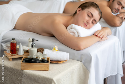 Aromatherapy massage on daylight ambiance or spa salon composition setup with focus decor and spa accessories on blur woman enjoying blissful aroma spa massage in resort or hotel background. Quiescent