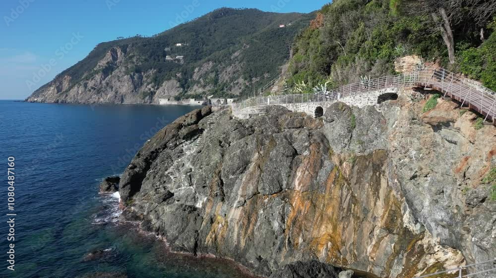 Italy , Liguria , Genoa - the seaside way via del mare, drone aerial view of seafront walk in Framura , seaside town near the Cinque Terre - tourist attraction destination for summer , volcanic rock Italy , Liguria , Genoa - the seaside way via del mare, drone aerial view of seafront walk in Framura , seaside town near the Cinque Terre - tourist attraction destination for summer , volcanic rock