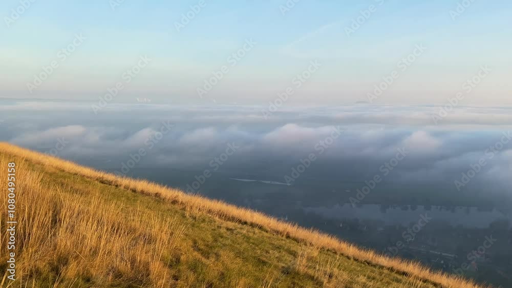 Panoramic view of the Central Bohemian hills hidden under the fog from the Radobyl hill in the Czech Republic. In the distance, the iconic mountain Rip Panoramic view of the Central Bohemian hills hidden under the fog from the Radobyl hill in the Czech Republic. In the distance, the iconic mountain Rip