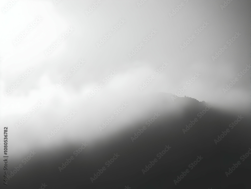 Fototapeta premium Photo Misty Mountain Peak through Clouds