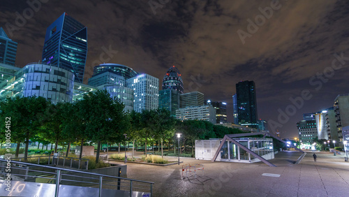 Paris cityscape with modern buildings in business district La Defense timelapse hyperlapse by night. Paris, France photo