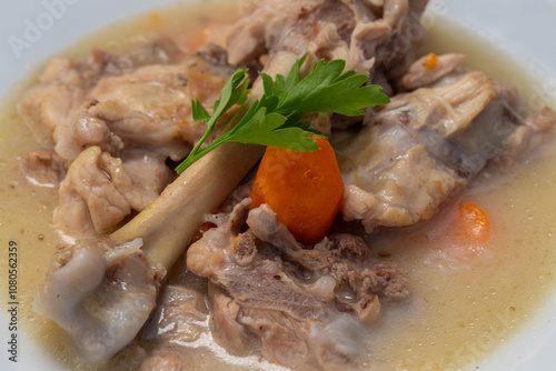 Obraz na płótnie Boiled chicken thighs with potatoes and carrots in a white plate. Boiled chicken meat. w salonie