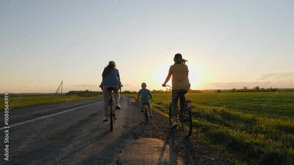 A family rides bicycles along a rural road at sunset, enjoying a warm evening in nature A family rides bicycles along a rural road at sunset, enjoying a warm evening in nature