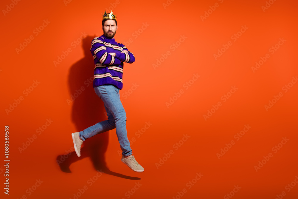 Fototapeta premium Full size photo of nice young male crossed hands jump run wear trendy striped violet outfit isolated on orange color background