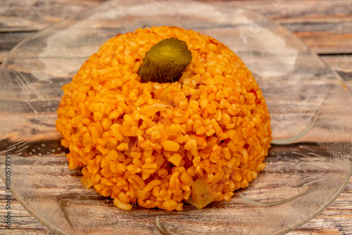 Traditional turkish bulgur pilaf with tomato sause in plate (Turkish name; meyhane pilavi) photo