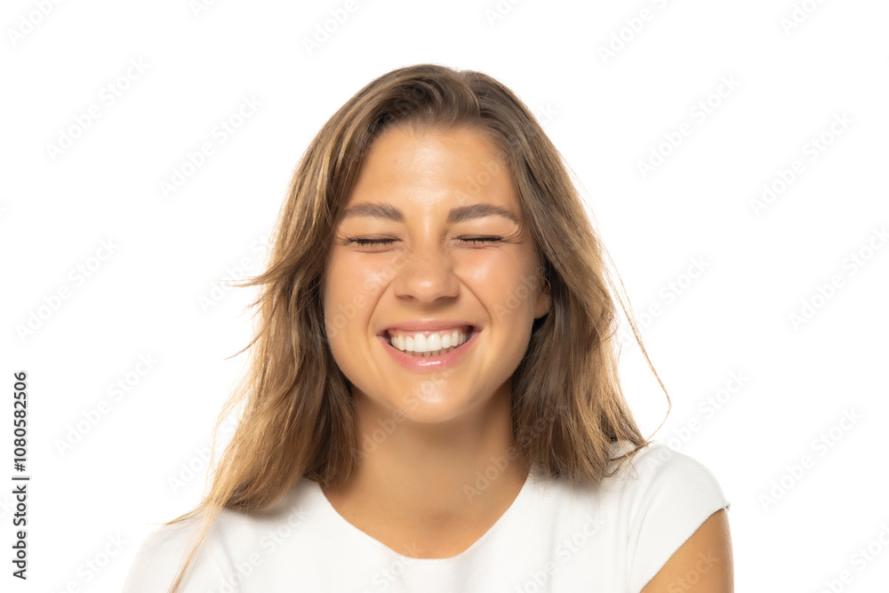Portrait of young smiling woman with a light makeup winks on a white studio background Portrait of young smiling woman with a light makeup winks on a white studio background