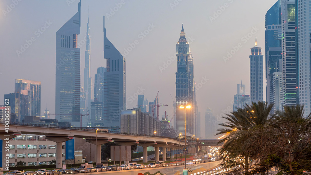 Fototapeta premium Traffic on intersection and bridge at the Sheikh Zayed Road day to night timelapse