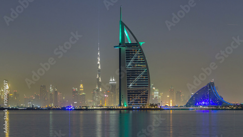 Fényképezés Skyline of Dubai by night with Burj Al Arab from the Palm Jumeirah timelapse hyperlapse