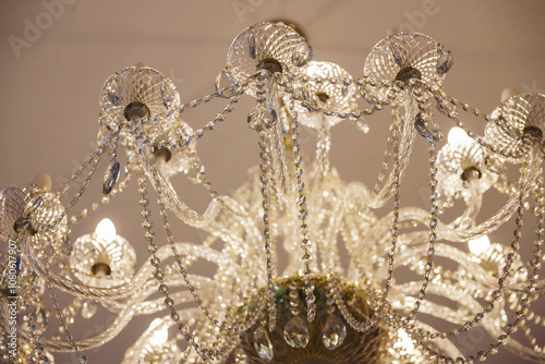 Luxury expensive chandelier hanging from the ceiling in the apartment. Crystal chandelier in the room. Close-up