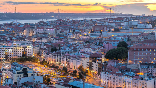 Lisbon after sunset aerial panorama view of city centre with red roofs at Autumn day to night timelapse, Portugal
