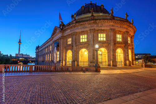 The Bode Museum in Berlin at twilight with the famous TV Tower in the back