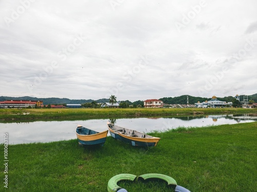 On the shores of Perlis, Malaysia, there are wooden houses and fishing boats. photo