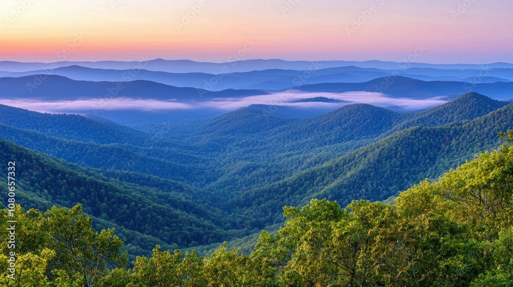 Fototapeta premium Serene Landscape of Rolling Hills and Majestic Mountains at Dusk with Soft Mist and Vibrant Sunset Colors Over a Peaceful Wilderness Scene