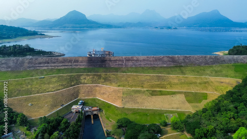 Aerial View of Jatiluhur, the Largest Dam in Indonesia. Bendungan Jatiluhur of Purwakarta. Multi-Purpose Embankment Dam on The Citarum River with Morning Glory Spillway photo