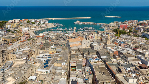 Aerial view of the Cathedral of Bisceglie, in Puglia, Italy. The Romanesque church of Saint Peter Apostle is located in the historic center of the town. In background is the port on Mediterranean Sea. photo