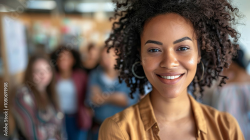 A woman with curly hair is smiling and posing for a picture