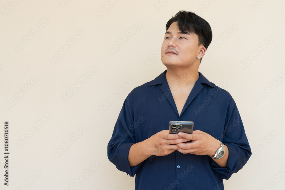 Portrait of Handsome Young Asian Man Against Plain Background Portrait of Handsome Young Asian Man Against Plain Background
