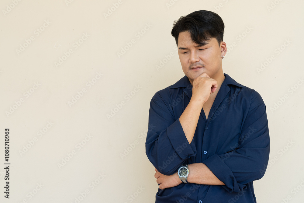 Portrait of Handsome Young Asian Man Against Plain Background