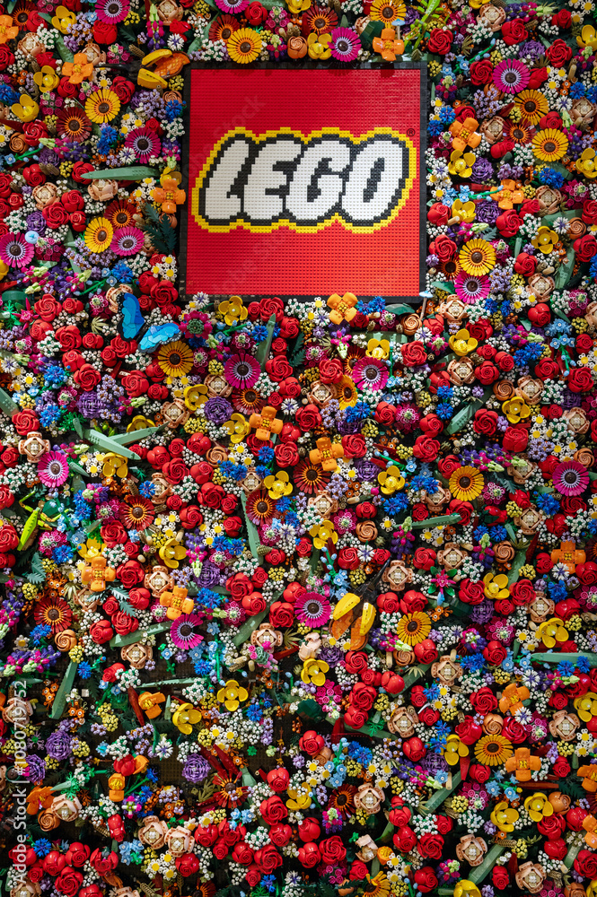 Obraz premium Lego logo surrounded by colorful Lego flowers in Lego store