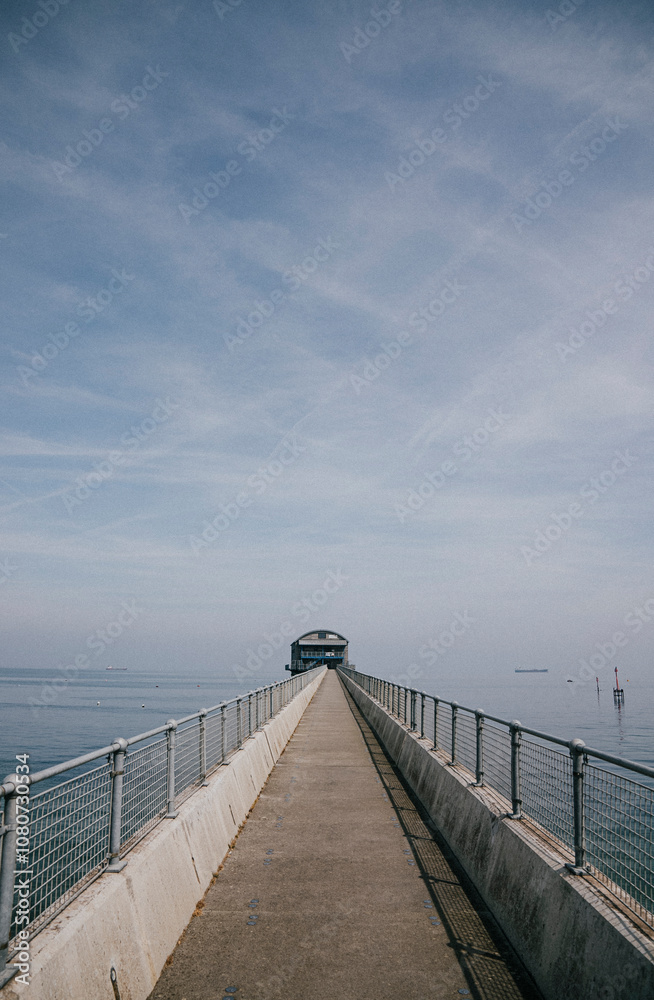 Obraz premium wide view of the road of a bridge on the sea attached to the harbour