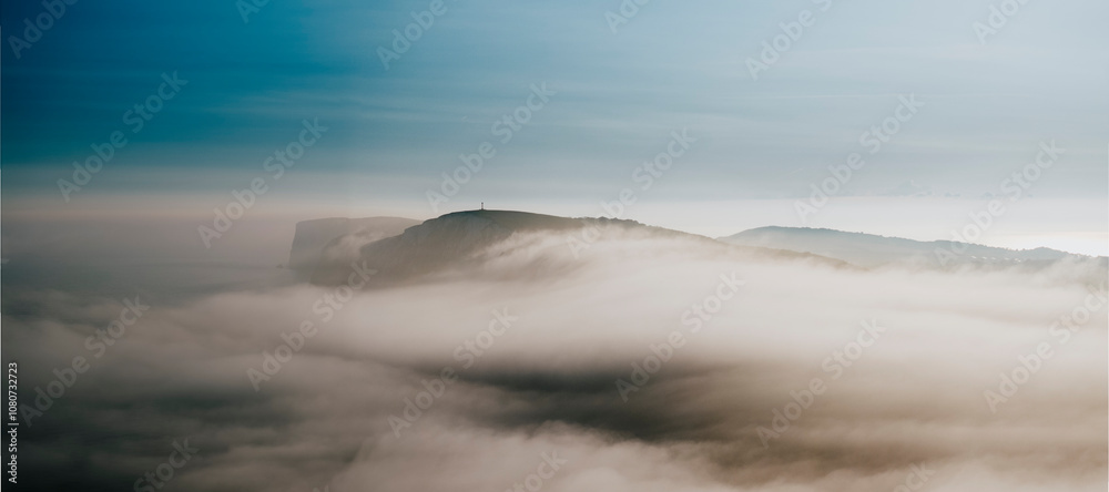 Fog and clouds over the mountains of the island in the sea Fog and clouds over the mountains of the island in the sea