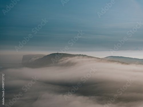 Fog and clouds over the mountains of the island in the sea