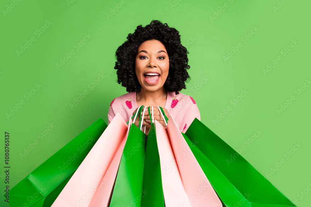 Photo of pretty young girl hold shopping bags excited wear strawberry print pink outfit isolated on green color background Photo of pretty young girl hold shopping bags excited wear strawberry print pink outfit isolated on green color background