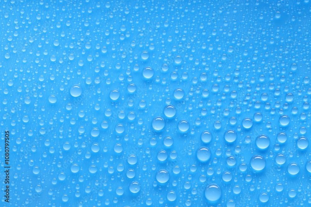 Water drops on blue background, top view Water drops on blue background, top view