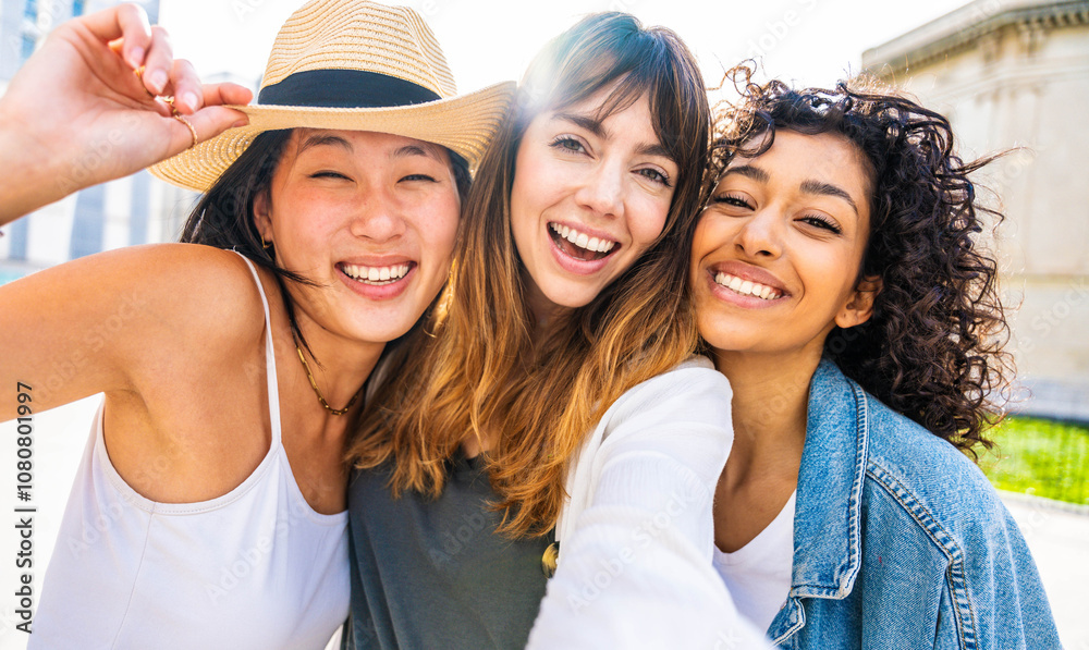 Multiracial three young women taking selfie portrait on city street - Happy female friends having fun together hanging outside - Life style concept with beautiful girls enjoying summer holidays Multiracial three young women taking selfie portrait on city street - Happy female friends having fun together hanging outside - Life style concept with beautiful girls enjoying summer holidays