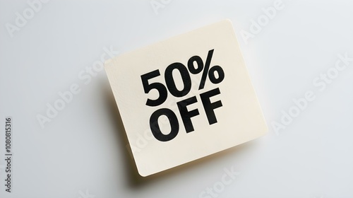 Black '50% OFF' Text on a Ivory Square Paper Note. White Background with Copy Space