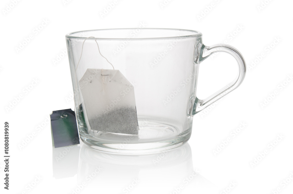Empty glass cup with tea bag close up on a white background Empty glass cup with tea bag close up on a white background