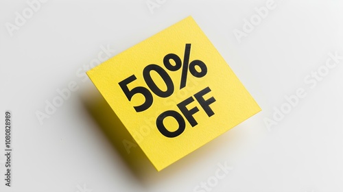 Black '50% OFF' Text on a Yellow Square Paper Note. White Background with Copy Space