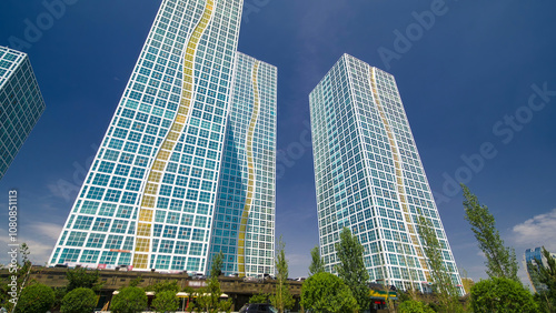 Modern towers of residential complex near Ishim River timelapse hyperlapse in Astana photo