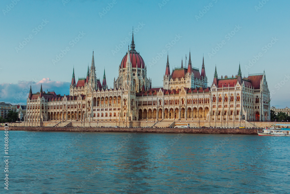 Fototapeta premium Majestic Hungarian Parliament Building with the Danube River in the Foreground: Iconic Views of Budapest's Historic Landmark