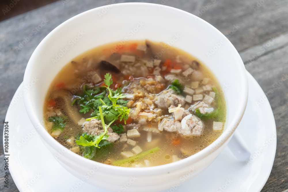 A delicious bowl of soup featuring minced meat, fresh herbs, and colorful vegetables, perfect for a comforting meal. A delicious bowl of soup featuring minced meat, fresh herbs, and colorful vegetables, perfect for a comforting meal.