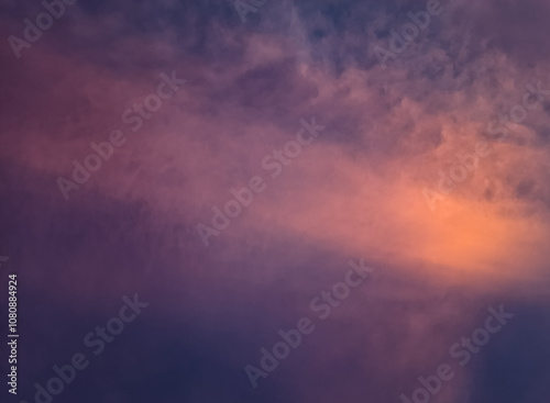 The beauty of the evening sky with clouds in shades of pink, purple, and orange, created by the sunlight casting a stunning gradient of colors on the horizon, evoking a peaceful and magical atmospher