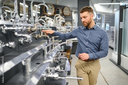 a customer in a hardware store in the plumbing department chooses a faucet for the kitchen