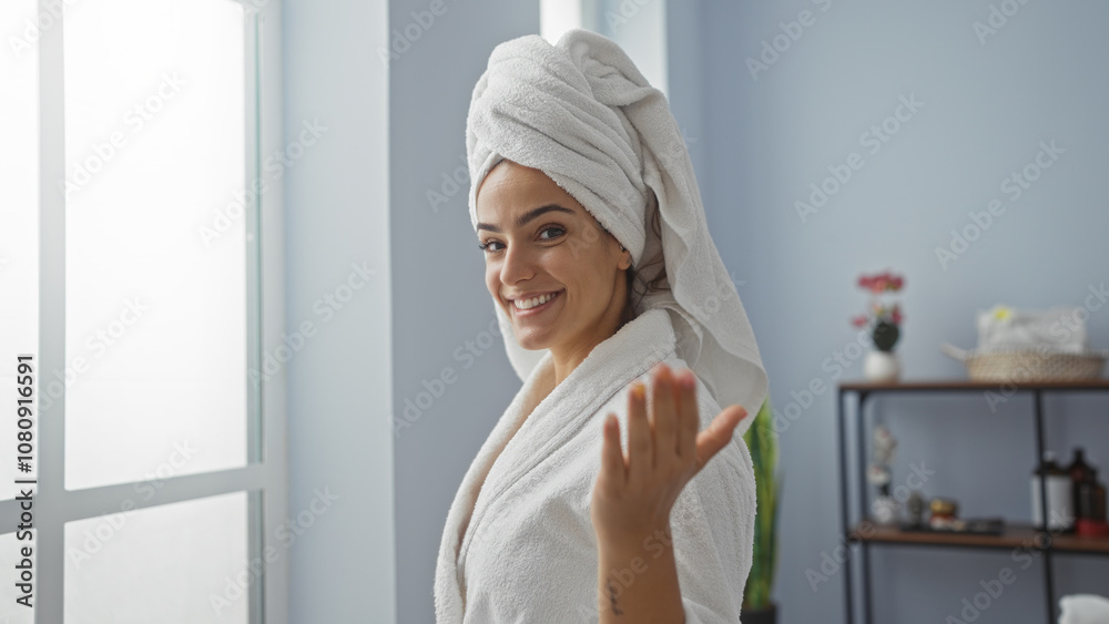 Woman smiling in wellness spa wearing bathrobe and towel on head indoors Woman smiling in wellness spa wearing bathrobe and towel on head indoors