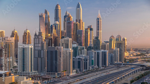 Dubai Marina skyscrapers aerial top view at sunrise from JLT in Dubai timelapse, UAE.