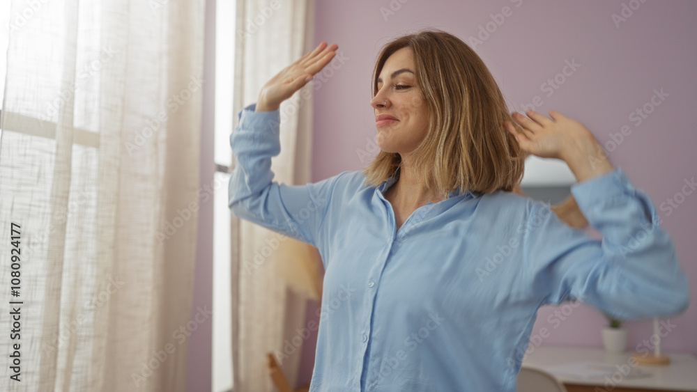 Woman stretching indoors in a bright living room with a smile, showcasing a casual and relaxed atmosphere at home Woman stretching indoors in a bright living room with a smile, showcasing a casual and relaxed atmosphere at home