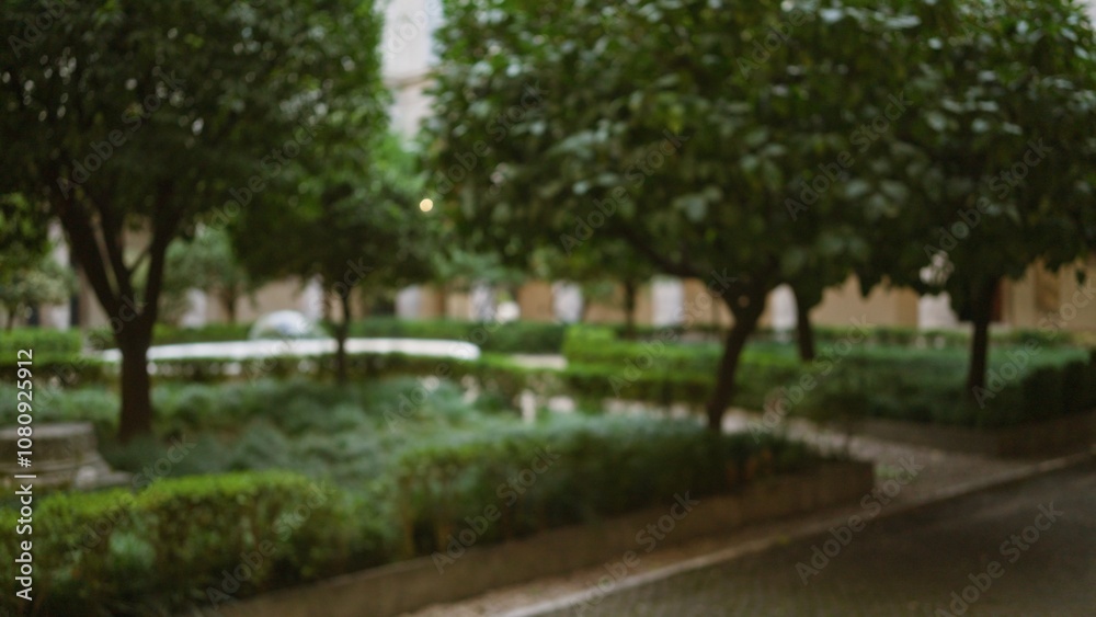 Blurred garden scene with lush greenery and defocused trees creating a serene outdoor bokeh effect in a tranquil patio setting, showcasing peaceful nature vibes. Blurred garden scene with lush greenery and defocused trees creating a serene outdoor bokeh effect in a tranquil patio setting, showcasing peaceful nature vibes.