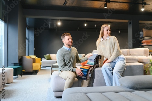 Couple choosing sofa and pillows at furniture store photo