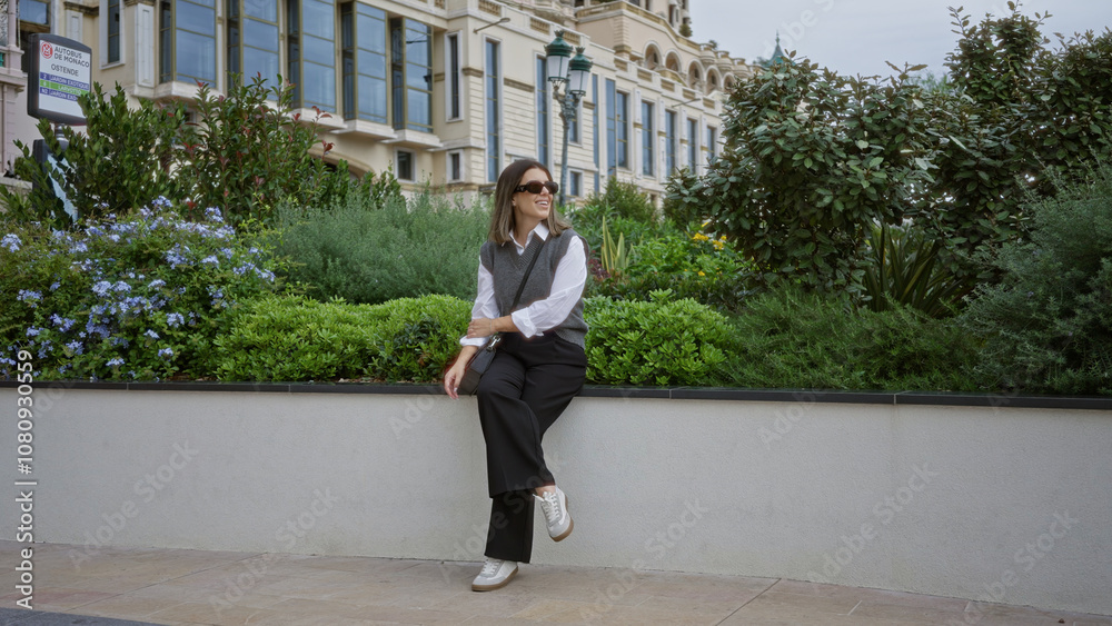 Woman smiling outdoors in monaco surrounded by lush greenery and elegant architecture, portraying a serene and luxurious atmosphere. Woman smiling outdoors in monaco surrounded by lush greenery and elegant architecture, portraying a serene and luxurious atmosphere.