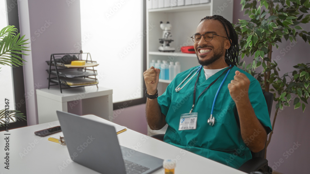 Young man in medical scrubs celebrating success in a clinic office setting with laptop and stethoscope, expressing happiness in a professional healthcare environment. Young man in medical scrubs celebrating success in a clinic office setting with laptop and stethoscope, expressing happiness in a professional healthcare environment.