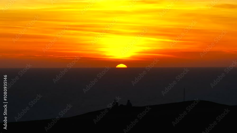 Sunset view in the sea and yellow clouds in the sky with reddish tone Sunset view in the sea and yellow clouds in the sky with reddish tone