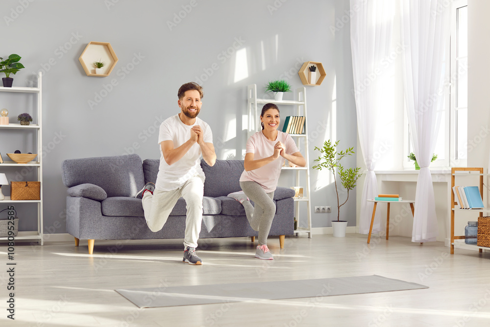 Fototapeta premium Family couple of an athletes, exercises together at home, performing squats. Fitness routine showcases commitment to an active sporty lifestyle, promoting health and wellness within the family.