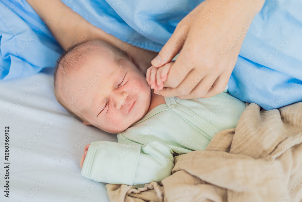A baby lies with the mother after childbirth, resting peacefully. The serene moment captures the bond between mother and child as they begin their journey together. The hospital environment ensures a