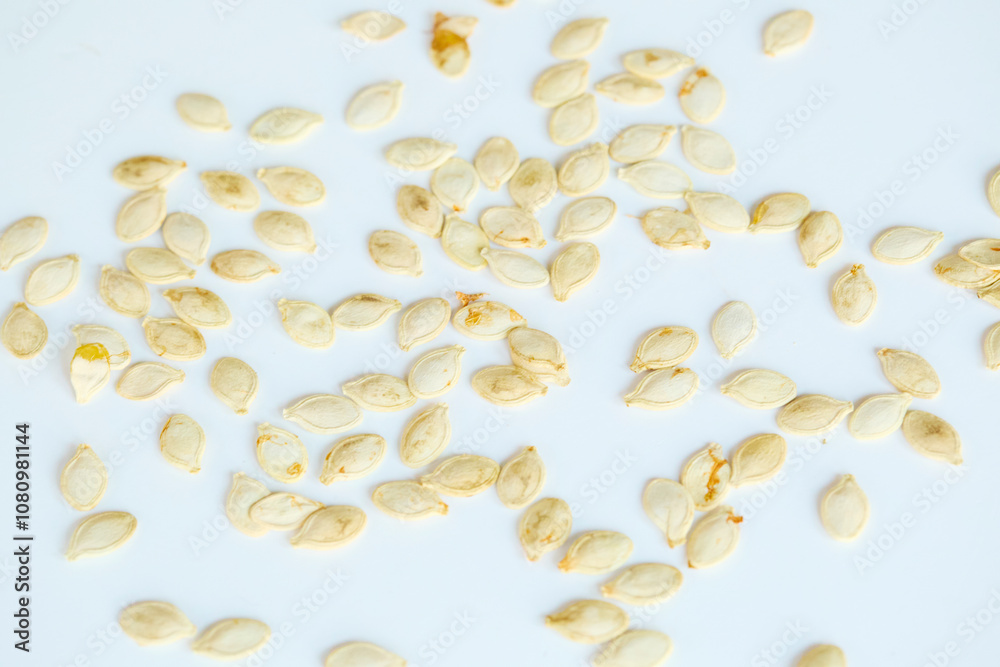 Pumpkin squash seeds on a white background. Pumpkin squash seeds on a white background.