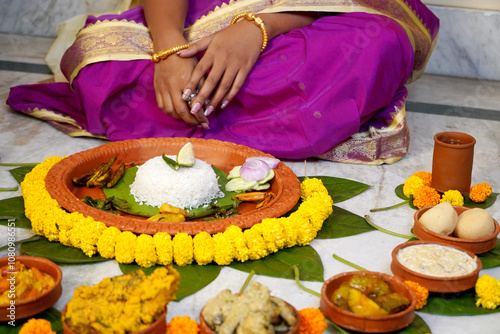 Bride taking aiburobhat from her family with different types of delicious bengali food items before marriage photo
